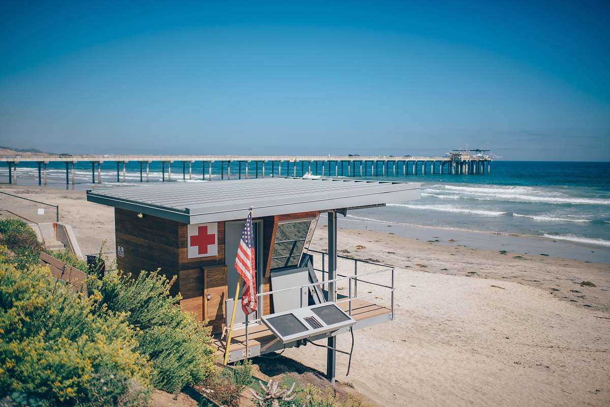 boardwalk brown and gray shed near beach and port beach